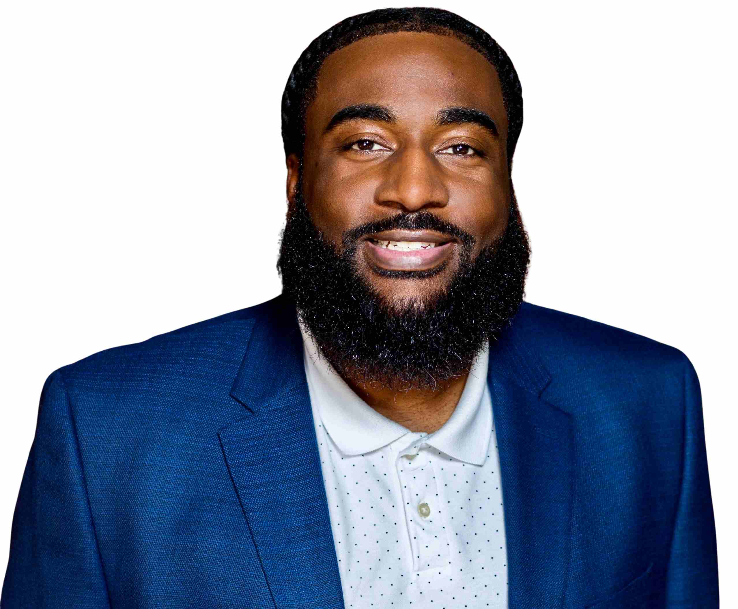 Smiling man with a beard wearing a blue suit and white collared shirt, facing the camera